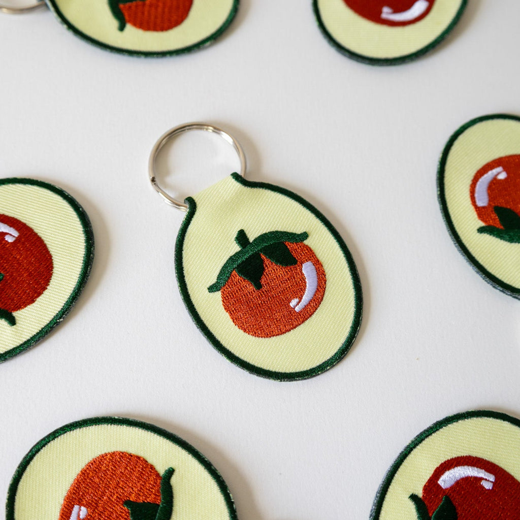 embroidered tomato keychains on a white background