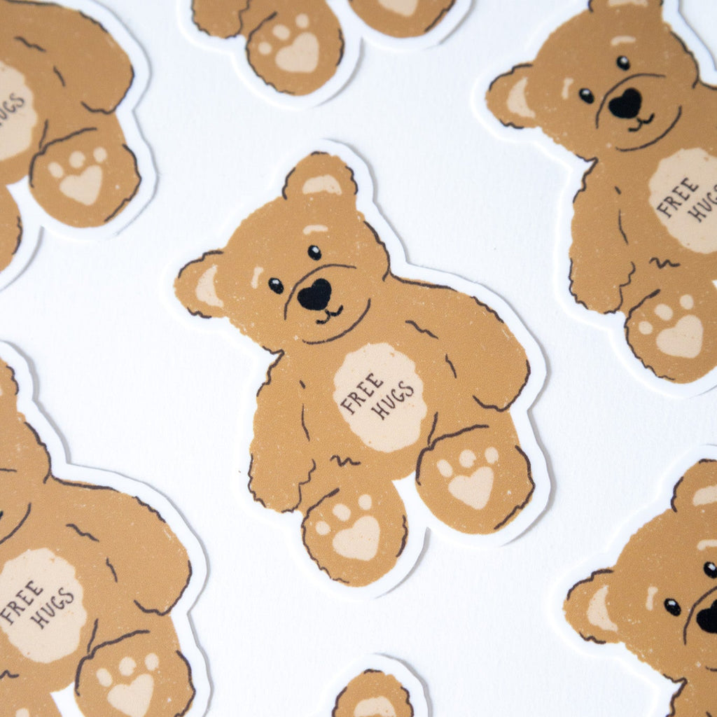 Pattern of brown teddy bears with 'Free Hugs' text on a white background